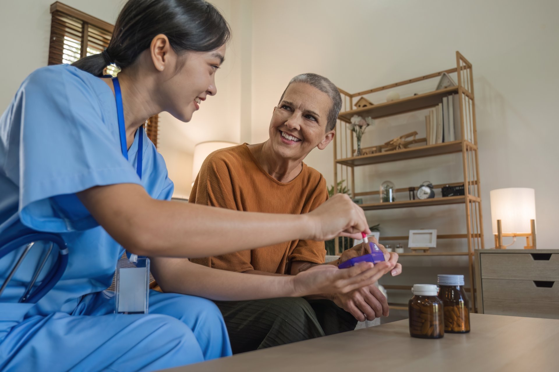 Home health aide assists elderly patient with medication Home health aide assists elderly patient with medication