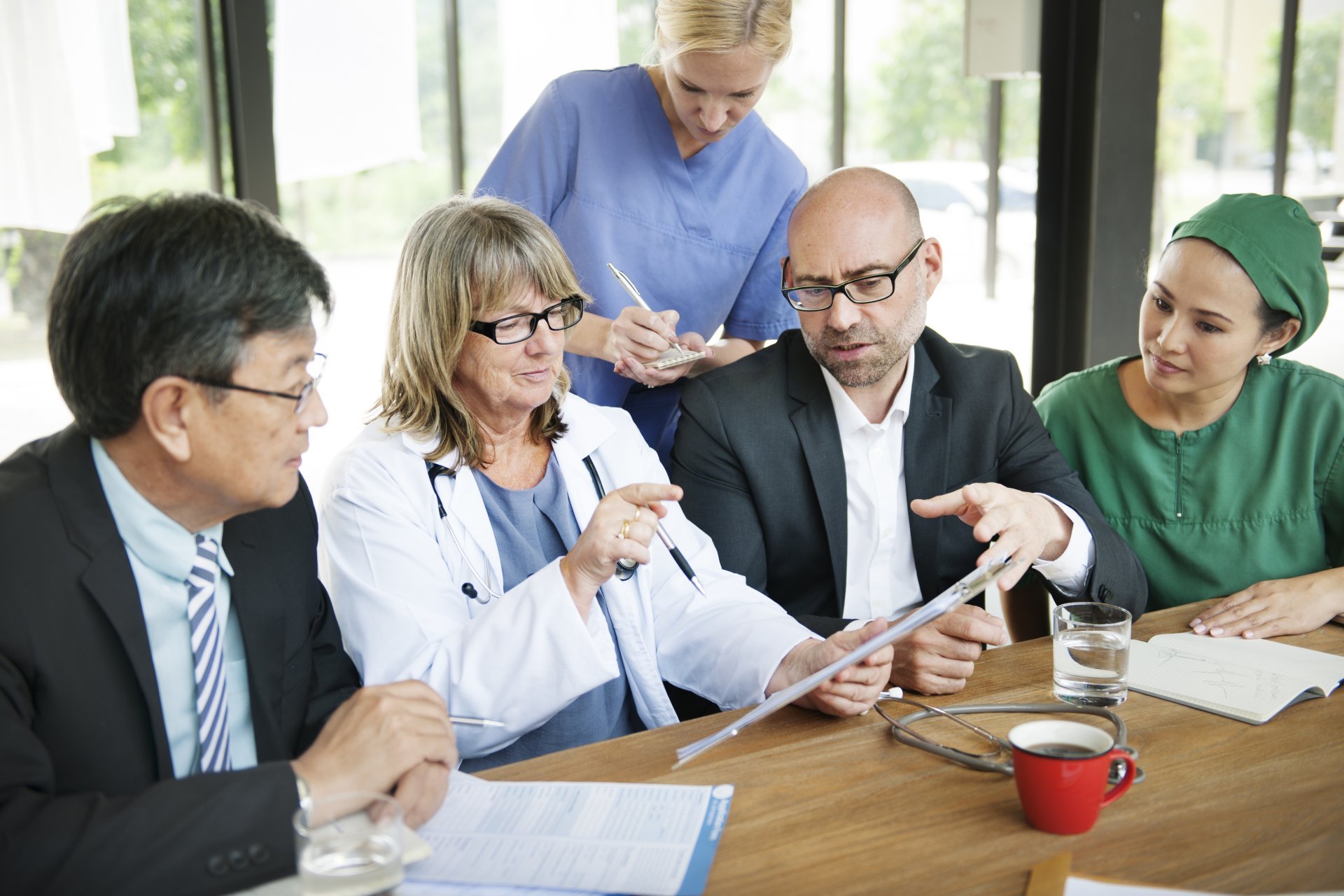 A group of medical professionals hold a meeting at their facility.