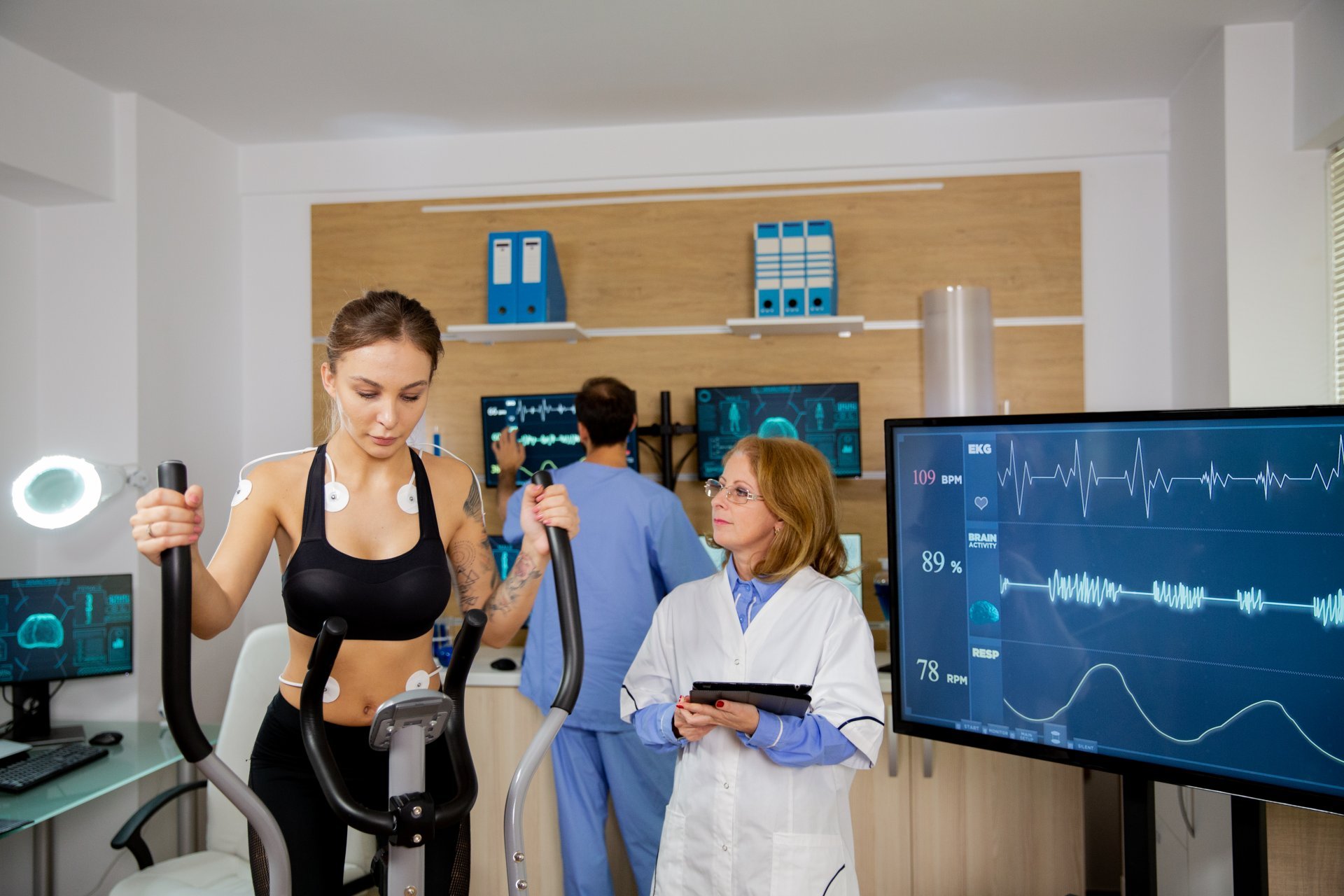 A woman exercises under supervision from a clinician