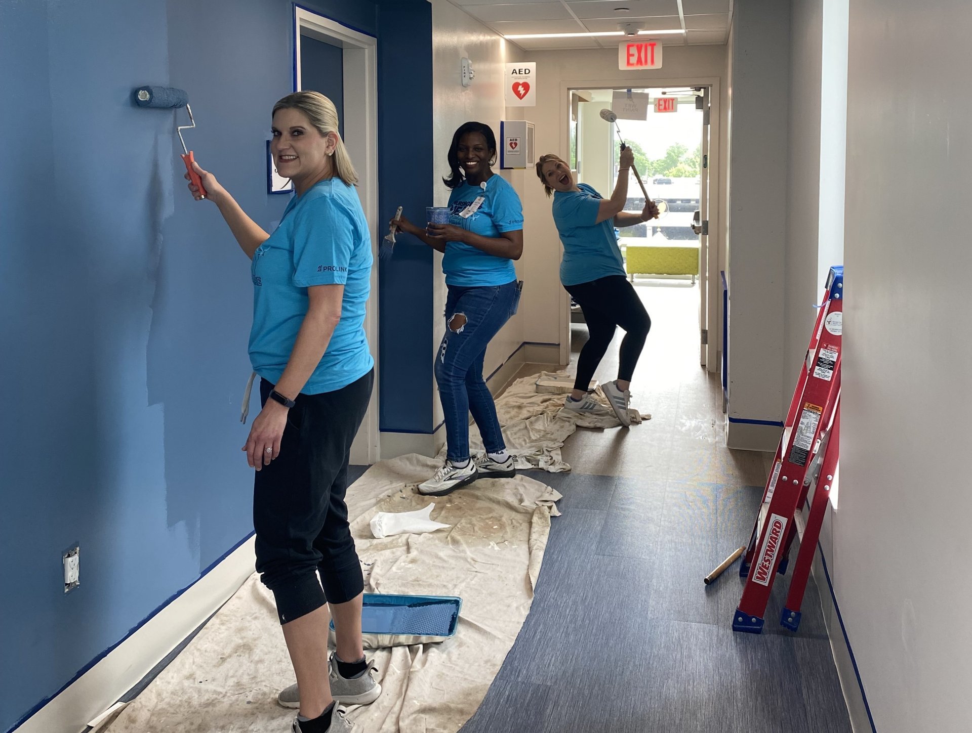 The Prolink volunteer team paints a hallway at the Ronald McDonald House at Cincinnati Children's Hospital.