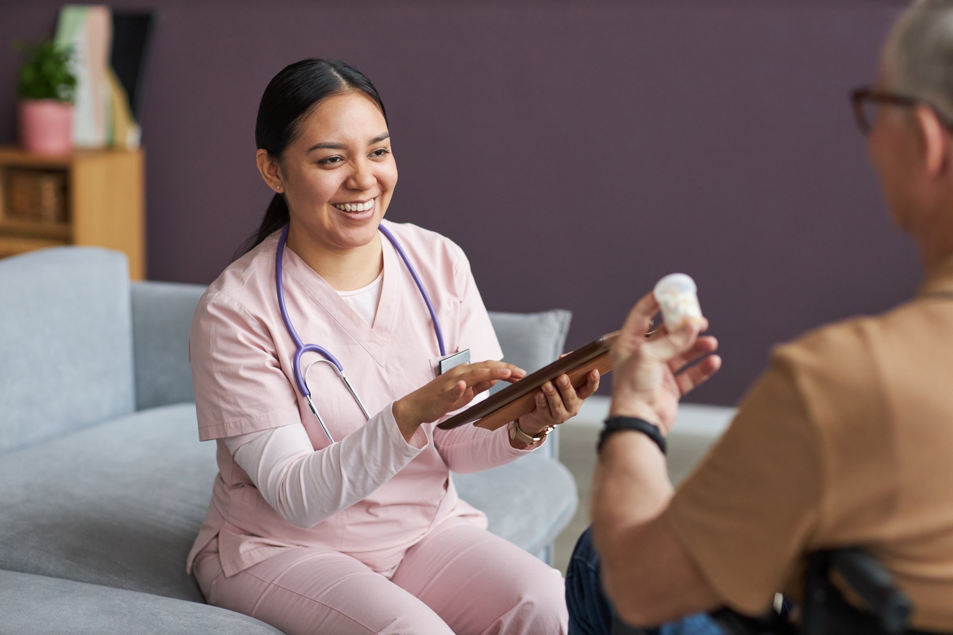 A nurse practitioner prescribes medication to her patient.