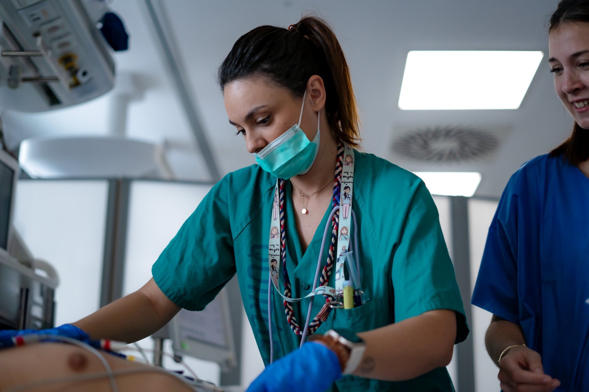 Nurses performing electrocardiogram on a patient