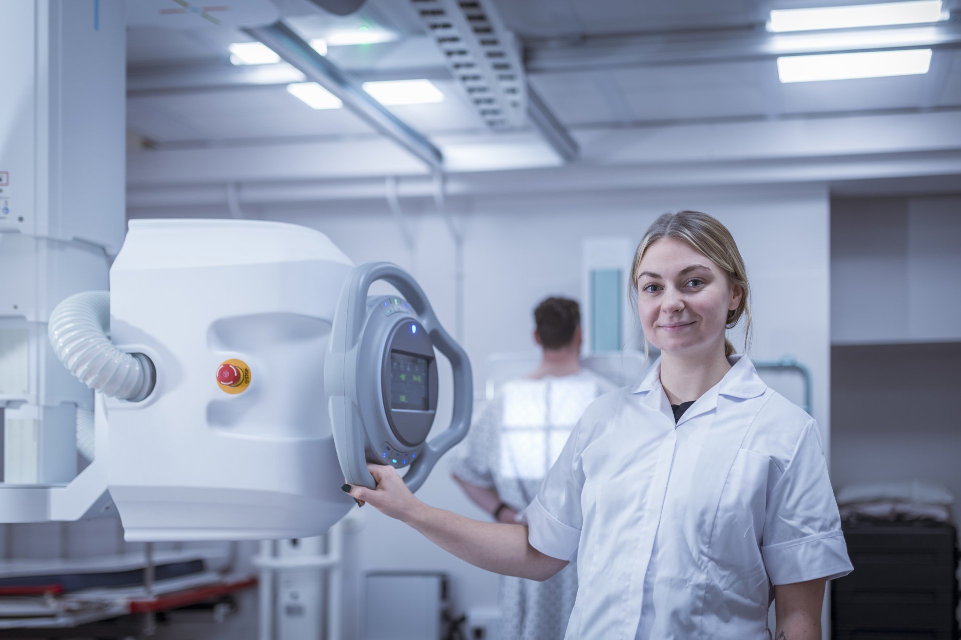 Radiologist setting up chest x-ray using radiology equipment