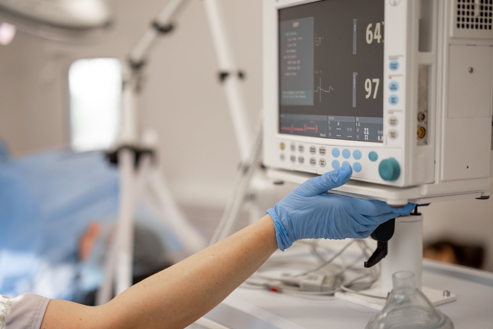 A clinician uses monitoring equipment during a procedure