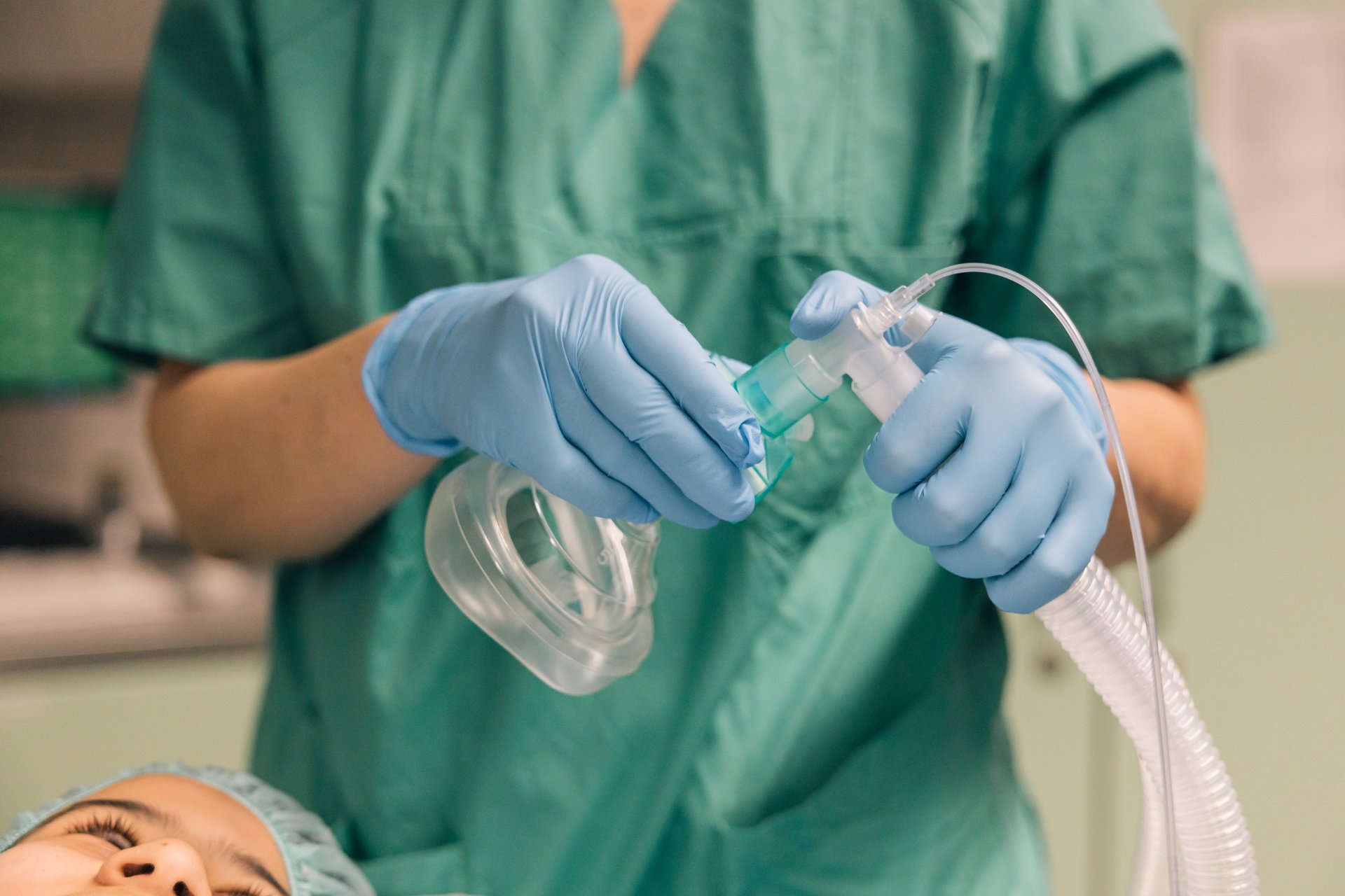 Respiratory therapist applies a ventilation mask on a patient Respiratory therapist applies a ventilation mask on a patient