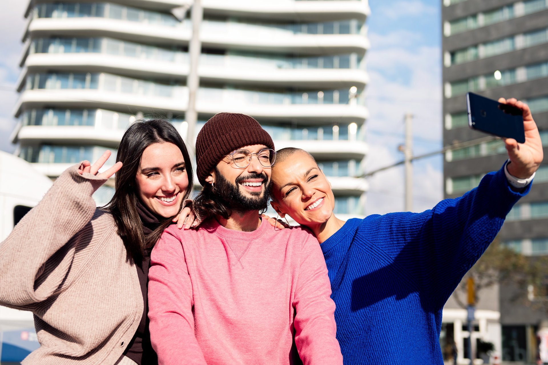 Three friends in a city taking a selfie