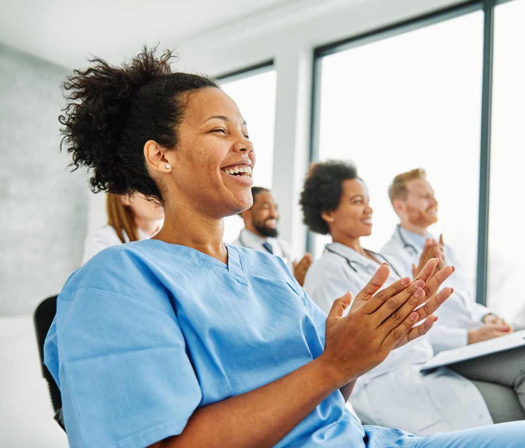 Happy smiling nurses and doctors in classroom